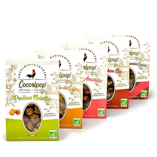 Le Pack Découverte Pralinés Bio – assortiment bio de pralines artisanales incluant cacahuètes, noisettes, amandes, amandes cacao et noix de cajou caramélisées, présenté sur fond blanc. bio