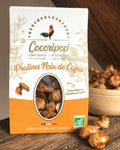 Pralines Noix de Cajou Bio  – un parfait équilibre entre le croquant des noix de cajou torréfiées et la douceur du caramel doré. Une mise en scène élégante pour une confiserie artisanale et gourmande. bio