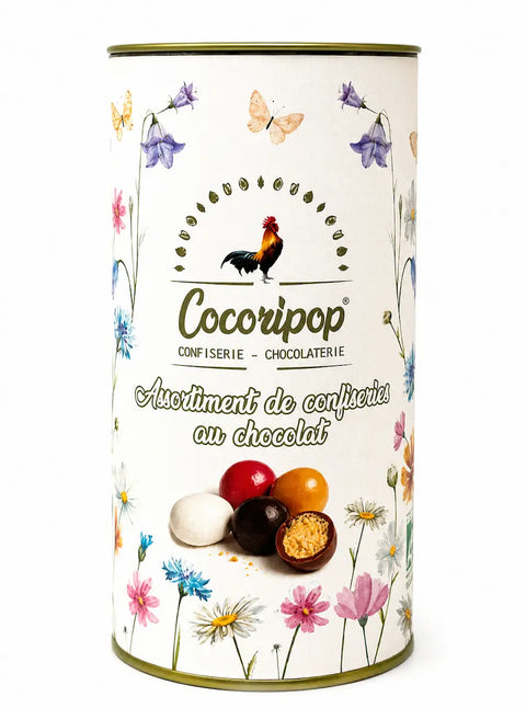 Boîte Cylindre de Pâques fabriquée à Saint-Germain-du-Puy, composée d'amandes dragéifiées et de billes de céréales croustillantes enrobées de chocolats biologiques.