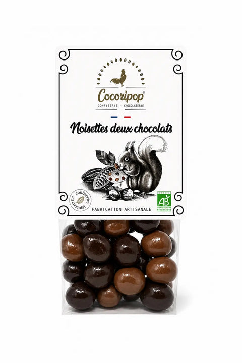 Noisettes deux chocolats bio torréfiées et enrobées de chocolat noir et chocolat au lait, fabriquées artisanalement près de Bourges dans le Berry.